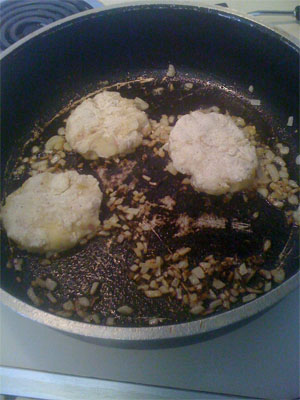 potato pancakes frying in pan